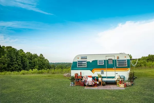 Electric caravan in a green field
